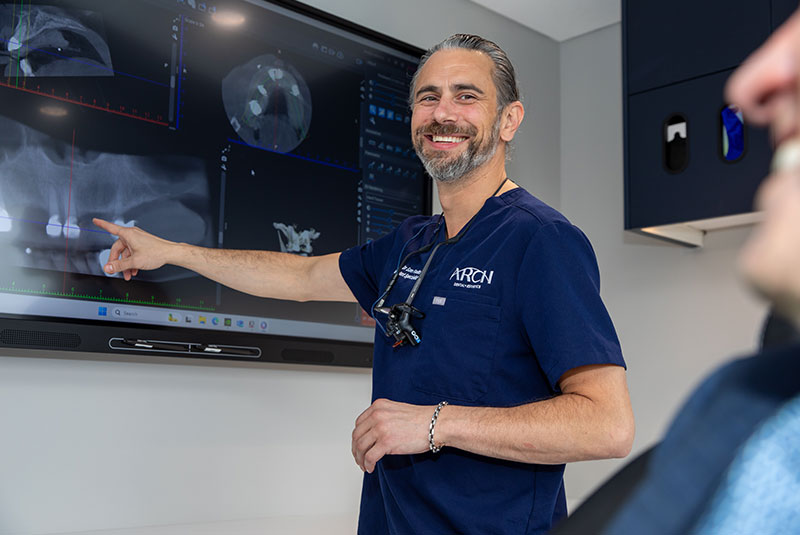 doctor Pointing at dental implants