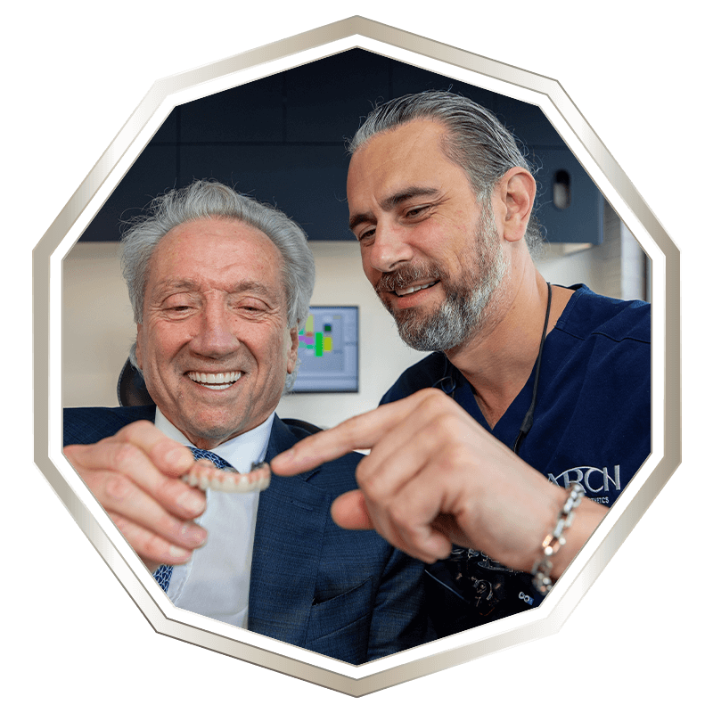Patient holding full arch implants